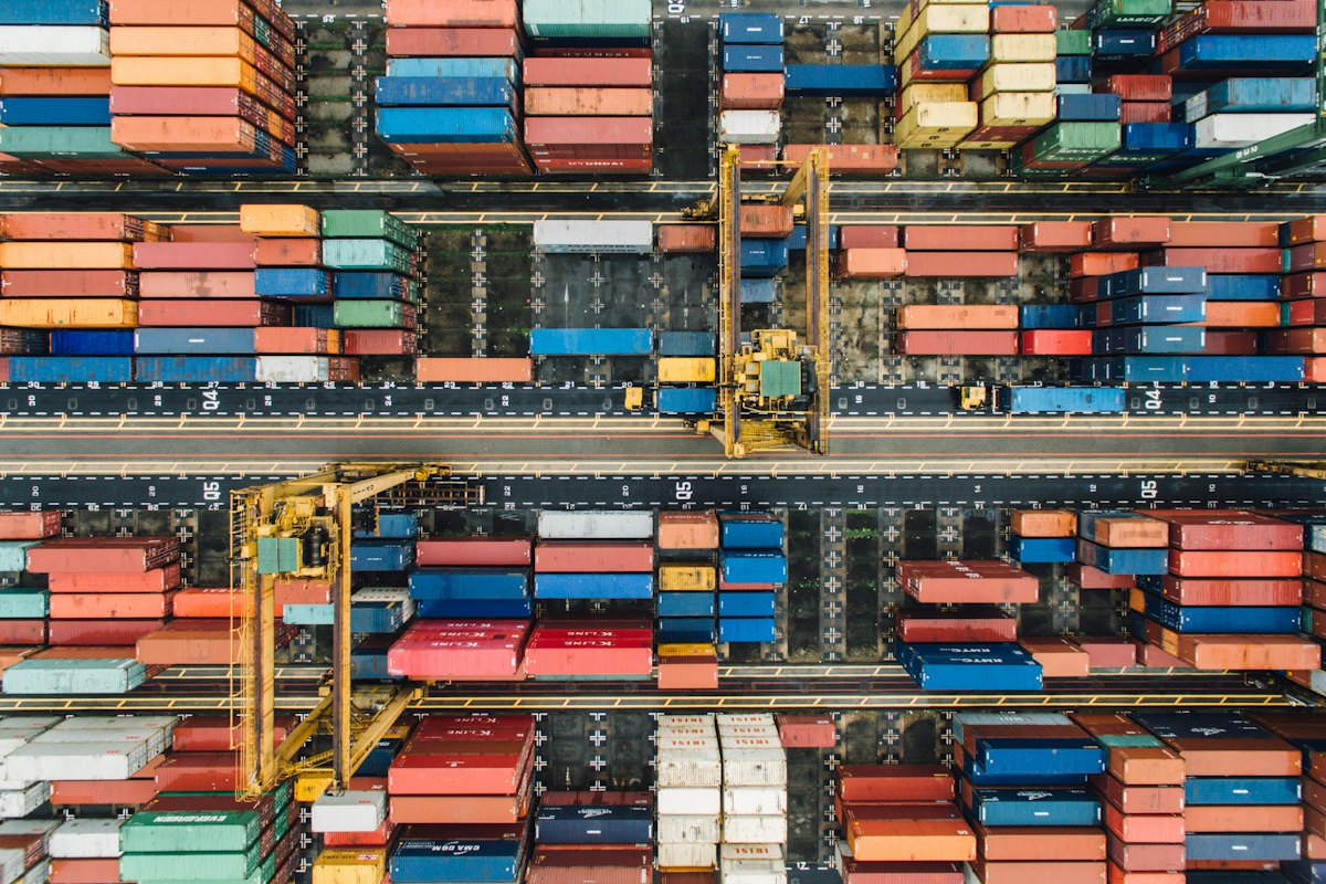 Aerial view of colorful shipping containers stacked at a port